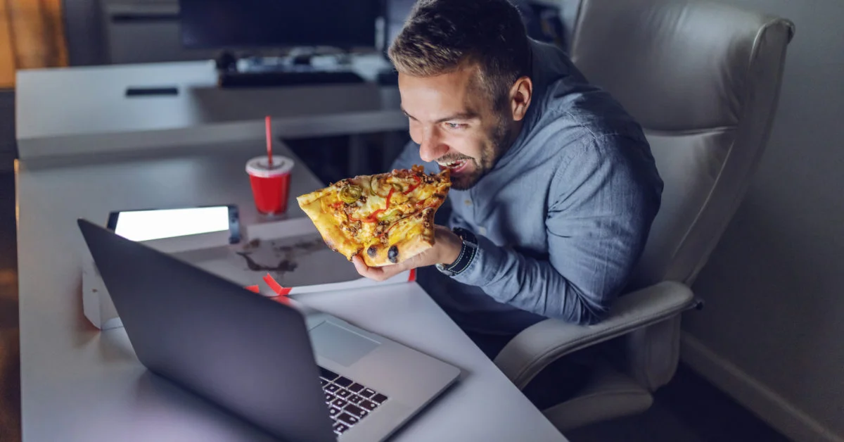 Man eating pizza at night 1200x628 1 Man eating pizza at night 1200x628 1